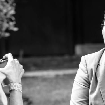 Image description: Black and white photo of Shadi Amin talking to another person