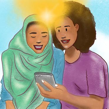 Two african women looking a mobile phone together