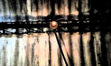 Image description: A single light bulb on the ceiling Image description: A single light bulb on the ceiling