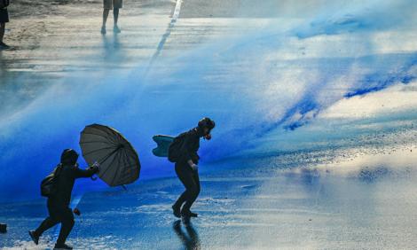 Image description: Water cannons on protestors in HOng Kong