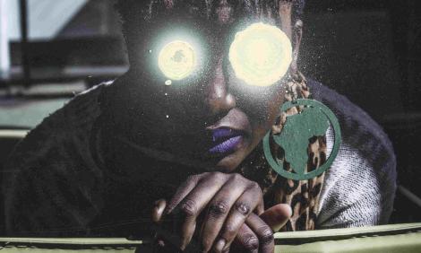 Image description: Black woman with Africa earring