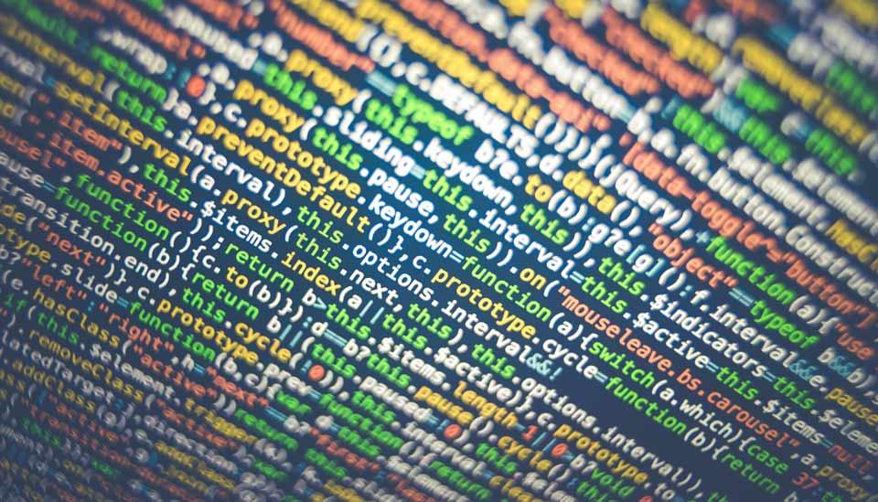 Image description: Close-up of colourful binary code