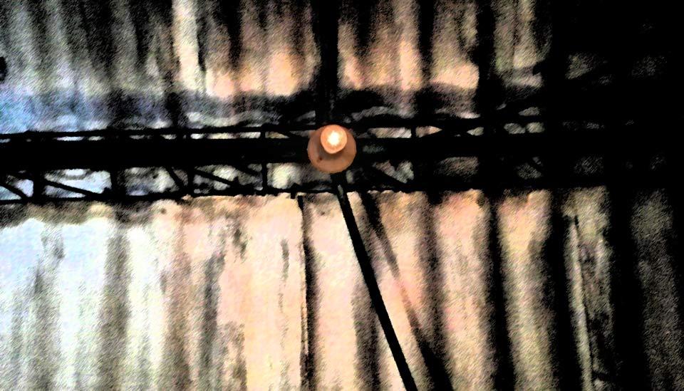 Image description: A single light bulb on the ceiling Image description: A single light bulb on the ceiling