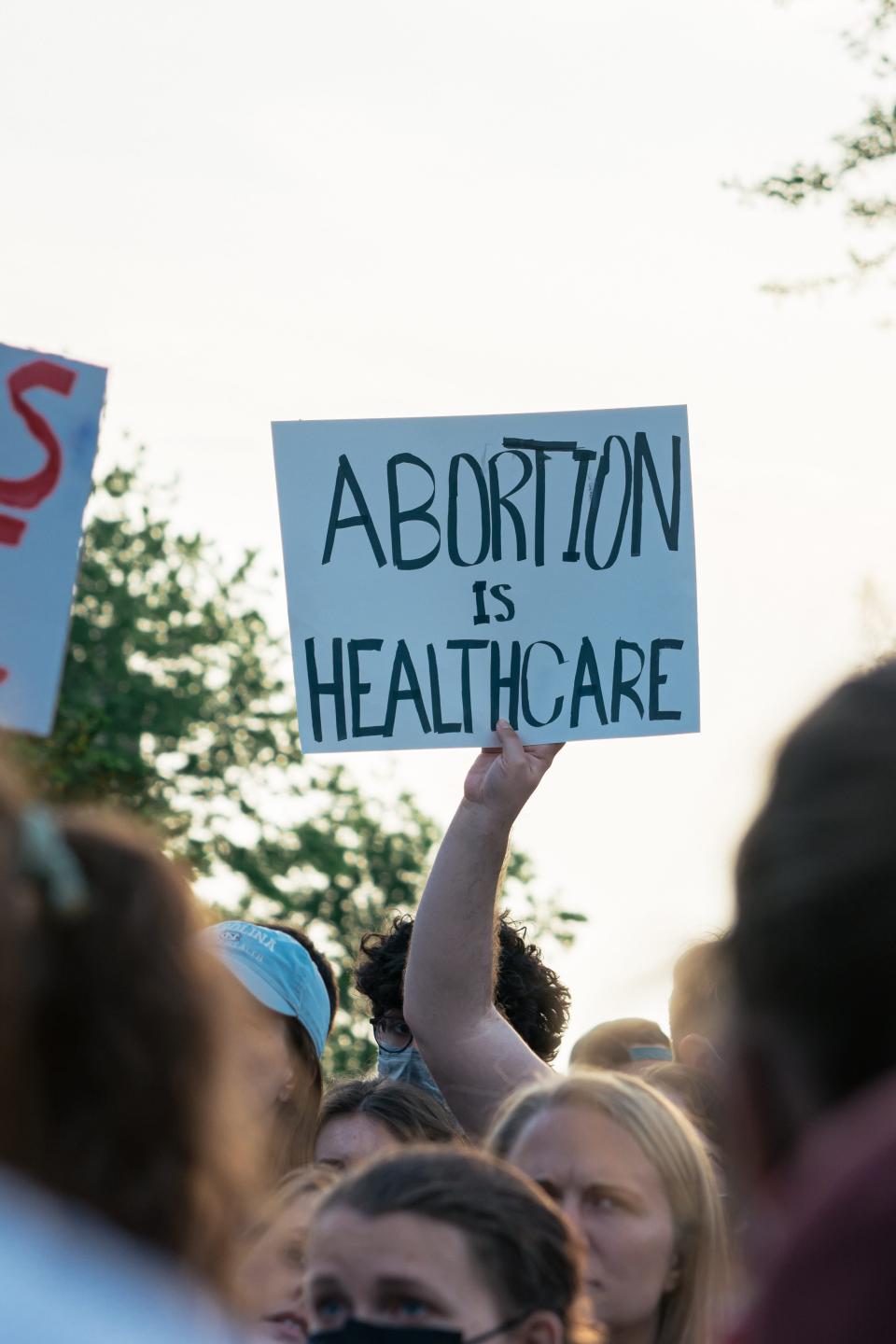 Placard reads, "Abortion is Healthcare". Photo by Gayatri Malhotra on Unsplash