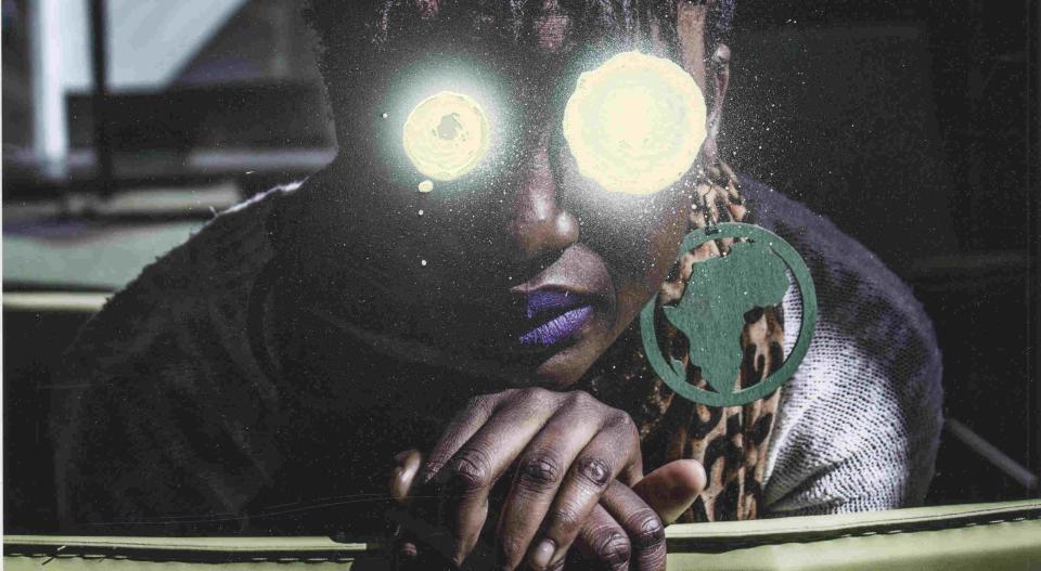 Image description: Black woman with Africa earring