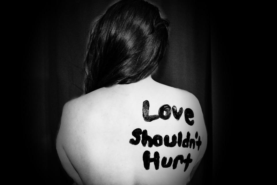 Image description: Back of woman with words painted